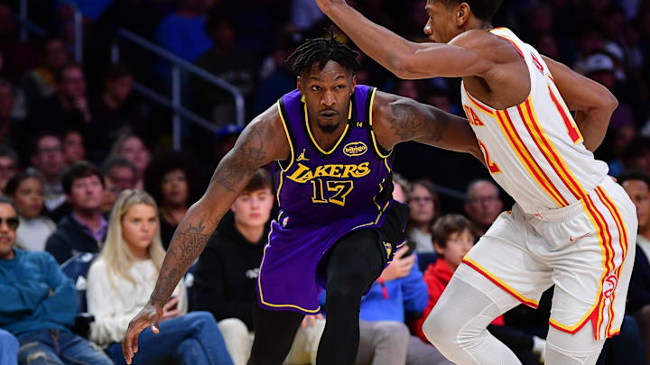 Jan 3, 2025; Los Angeles, California, USA; Los Angeles Lakers forward Dorian Finney-Smith (17) moves the ball against Atlanta Hawks forward De'Andre Hunter (12) during the second half at Crypto.com Arena. Mandatory Credit: Gary A. Vasquez-Imagn Images