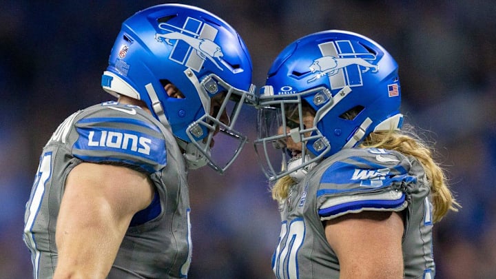 Detroit Lions defensive end Aidan Hutchinson, left, celebrates with teammate Alex Anzalone 