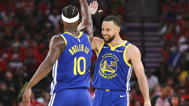 Apr 20, 2025; Houston, Texas, USA; Golden State Warriors guard Stephen Curry (30) celebrates with forward Jimmy Butler III (10) after a play during the third quarter against the Houston Rockets at Toyota Center. Mandatory Credit: Troy Taormina-Imagn Images