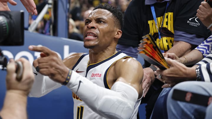 May 7, 2025; Oklahoma City, Oklahoma, USA; Denver Nuggets guard Russell Westbrook (4) reacts after a play and falling into fans in the second quarter against the Oklahoma City Thunder during game two of the second round for the 2025 NBA Playoffs at Paycom Center. Mandatory Credit: Alonzo Adams-Imagn Images