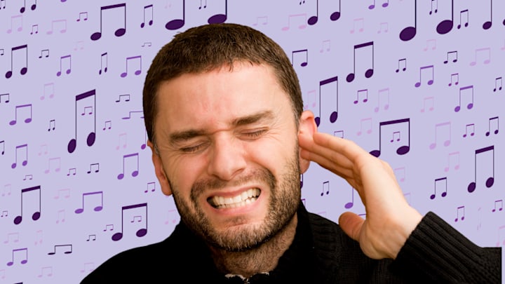 A person holding their ear with pain A person holding their ear with pain