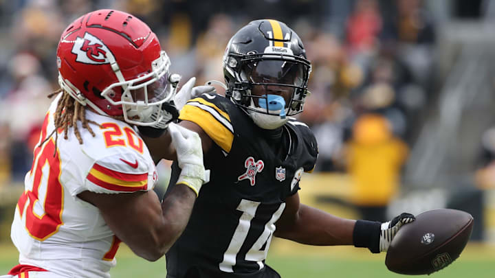 Dec 25, 2024; Pittsburgh, Pennsylvania, USA;  Pittsburgh Steelers wide receiver George Pickens (14) runs after a catch as Kansas City Chiefs safety Justin Reid (20) defends during the fourth quarter  at Acrisure Stadium. Mandatory Credit: Charles LeClaire-Imagn Images