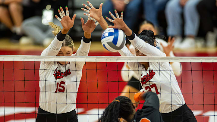 Nebraska middle blocker Andi Jackson (left) and outside hitter Harper Murray block a Florida A&M attack.