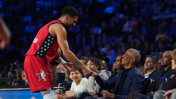 Feb 15, 2026; Inglewood, California, USA; Team USA Stars guard Devin Booker (1) of the Phoenix Suns high fives former president Barack Obama in game 1 during the 75th NBA All Star Game at Intuit Dome. Mandatory Credit: Kirby Lee-Imagn Images