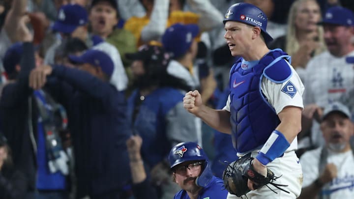 Los Angeles Dodgers catcher Will Smith (16) reacts after tagging out Toronto Blue Jays left fielder Davis Schneider (36) during the tenth inning in game three of the 2025 MLB World Series at Dodger Stadium on Monday.