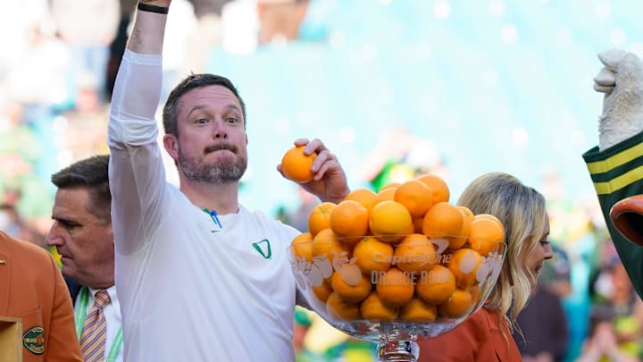 Oregon head coach Dan Lanning, left, throws out oranges as the team celebrates its win as the Oregon Ducks take on the Texas Tech Red Raiders in the Orange Bowl on Jan. 1, 2026, at Hard Rock Stadium in Miami, Florida.