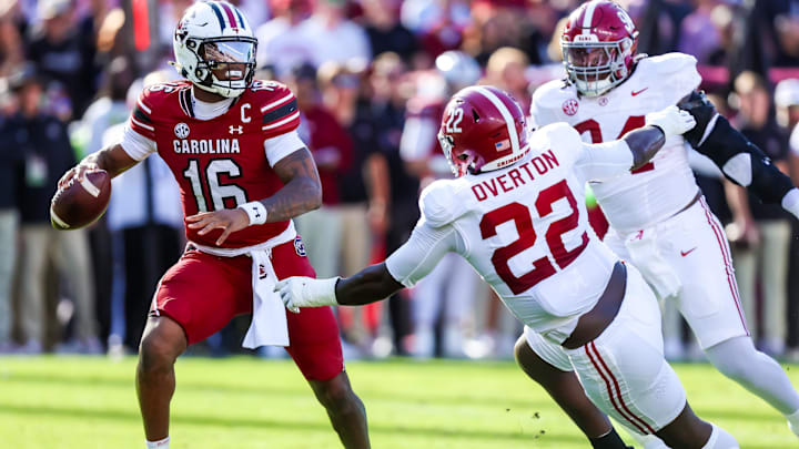 Oct 25, 2025; Columbia, South Carolina, USA; South Carolina Gamecocks quarterback Lanorris Sellers (16) throws under pressure from Alabama Crimson Tide defensive lineman Lt Overton (22) in the first quarter at Williams-Brice Stadium. Mandatory Credit: Jeff Blake-Imagn Images