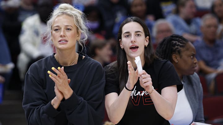 Jun 7, 2025; Chicago, Illinois, USA; Injured Indiana Fever guard Sophie Cunningham (8) and guard Caitlin Clark (22) react from the bench during the first half of a WNBA game against the Chicago Sky at United Center. Mandatory Credit: Kamil Krzaczynski-Imagn Images
