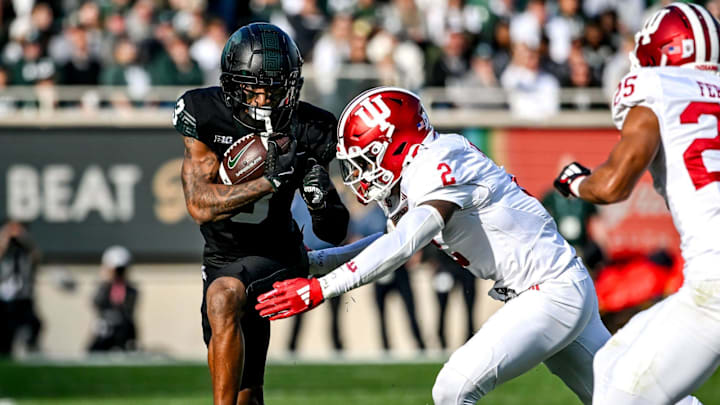 Michigan State's Montorie Foster Jr., left, runs for a gain as Indiana's Jailin Walker, right, closes in during the first quarter on Saturday, Nov. 2, 2024, at Spartan Stadium in East Lansing.