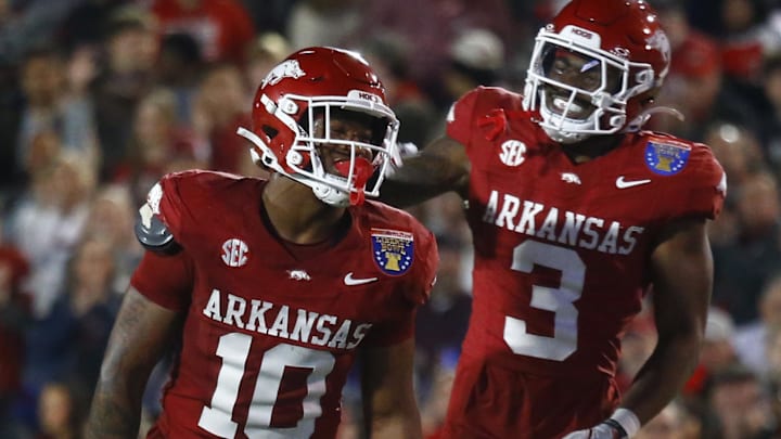 Arkansas Razorbacks linebacker Xavian Sorey Jr. (10) and defensive back Doneiko Slaughter (3) react after a defensive stop during the Liberty Bowl against the Texas Tech Red Raiders at Simmons Bank Liberty Stadium on Dec. 27.