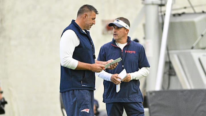Jun 10, 2025; Foxborough, MA, USA; New England Patriots head coach Mike Vrabel (l) and offensive coordinator Josh McDaniels (r) speak to each other during minicamp held in the WIN Field House at Gillette Stadium. Mandatory Credit: Eric Canha-Imagn Images