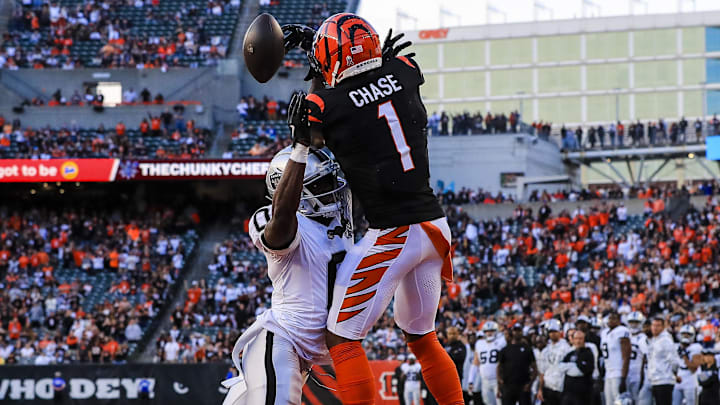 Nov 3, 2024; Cincinnati, Ohio, USA; Cincinnati Bengals wide receiver Ja'Marr Chase (1) attempts to catch a pass against Las Vegas Raiders cornerback Jakorian Bennett (0) in the second half at Paycor Stadium. Mandatory Credit: Katie Stratman-Imagn Images