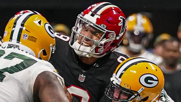 Atlanta Falcons quarterback Desmond Ridder (9) is hit by Preston Smith during the game against the Green Bay Packers in 2023.
