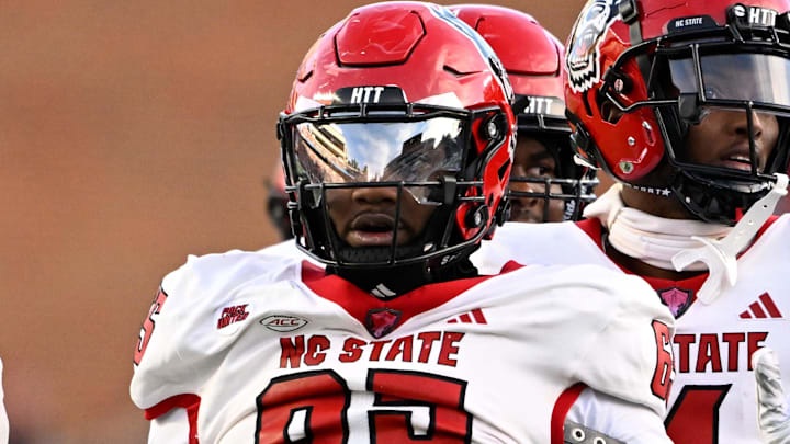Nov 30, 2024; Chapel Hill, North Carolina, USA; North Carolina State Wolfpack offensive tackle Jacarrius Peak (65) reacts in the first quarter at Kenan Memorial Stadium. Mandatory Credit: Bob Donnan-Imagn Images