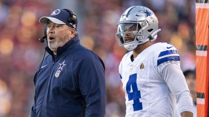 Dallas Cowboys coach Mike McCarthy and quarterback Dak Prescott watch the game from the sidelines.