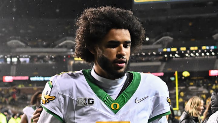 Nov 8, 2025; Iowa City, Iowa, USA; Oregon Ducks quarterback Dante Moore (5) runs off the field after the game against the Iowa Hawkeyes at Kinnick Stadium. Mandatory Credit: Jeffrey Becker-Imagn Images