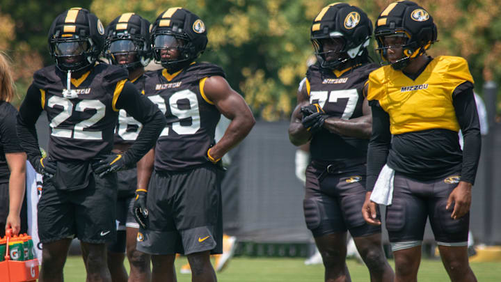 Aug 6, 2025; Columbia, MO, USA; Missouri Tigers running backs Tavorus Jones (22), Brendon Haygood (16), Ahmad Hardy (29) and Marquise Davis (77) take instruction during a fall camp practice at Mizzou Athletic Training Complex.
