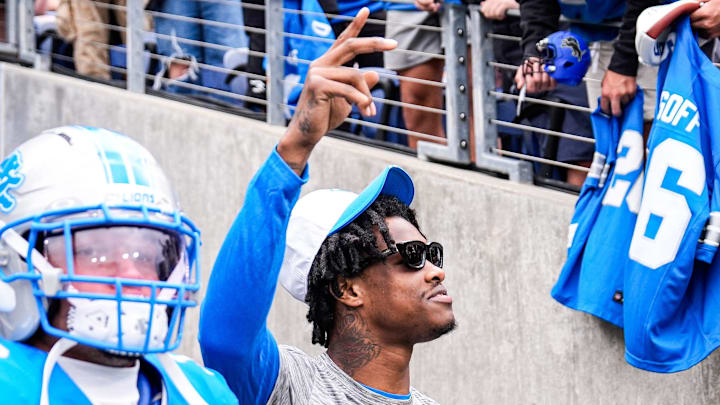 Detroit Lions wide receiver Jameson Williams (1) waves at fans during warm up ahead of the Hall of Fame Game 