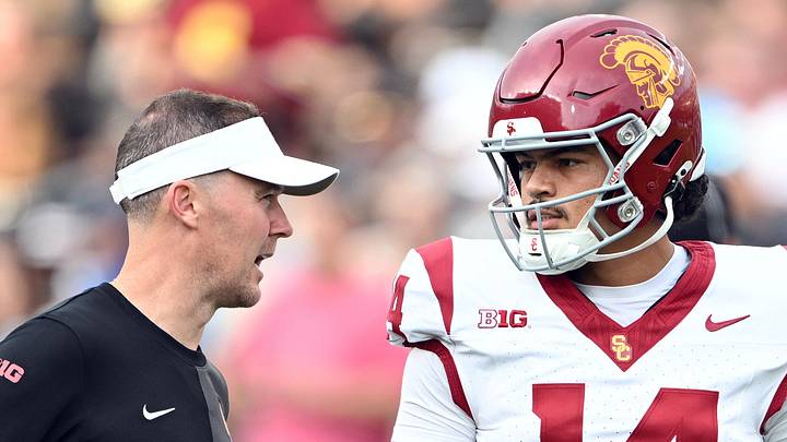 Sep 13, 2025; West Lafayette, Indiana, USA;  Southern California Trojans quarterback Jayden Maiava (14) talks with Southern California Trojans head coach Lincoln Riley  before the game against the Purdue Boilermakers at Ross-Ade Stadium. Mandatory Credit: Marc Lebryk-Imagn Images