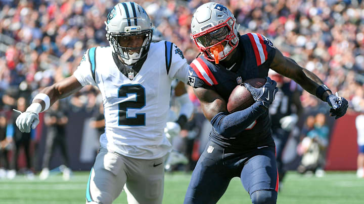 New England Patriots wide receiver Stefon Diggs (8) runs the ball while Carolina Panthers cornerback Mike Jackson (2) defends during the first half at Gillette Stadium.