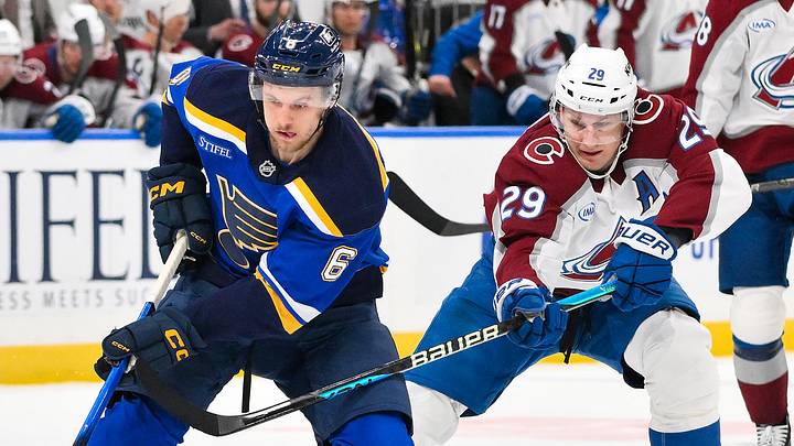 Apr 7, 2026; St. Louis, Missouri, USA; St. Louis Blues defenseman Philip Broberg (6) controls the puck as Colorado Avalanche center Nathan MacKinnon (29) defends during the second period at Enterprise Center. Mandatory Credit: Jeff Curry-Imagn Images