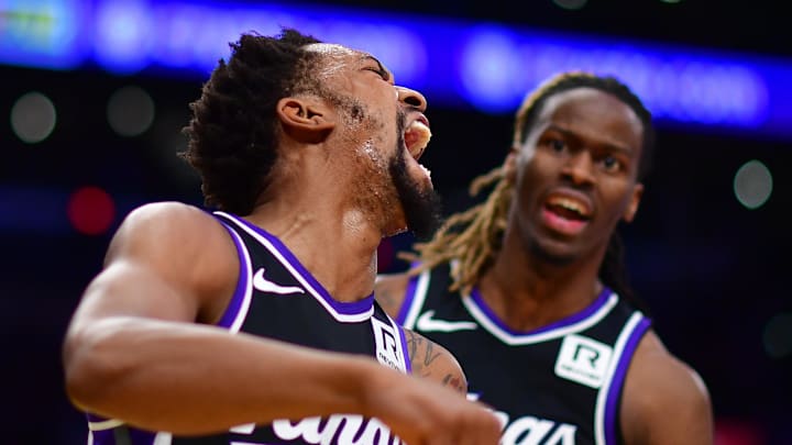 Dec 28, 2024; Los Angeles, California, USA; Sacramento Kings guard Malik Monk (0) reacts after guard Keon Ellis (23) scores a basket against the Los Angeles Lakers during the first half at Crypto.com Arena. Mandatory Credit: Gary A. Vasquez-Imagn Images