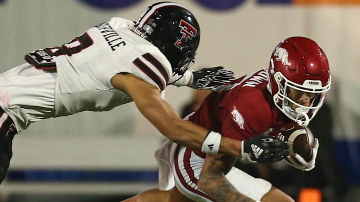 Arkansas Razorbacks wide receiver CJ Brown (17) runs after a catch as Texas Tech Red Raiders defensive linemen E'Maurion Banks (8) makes the tackle during the forth quarter at Simmons Bank Liberty Stadium.