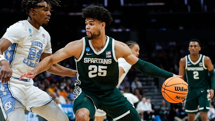 Michigan State forward Malik Hall (25) dribbles against North Carolina forward Jae'Lyn Withers (24) during the first half of the NCAA tournament West Region second round at Spectrum Center in Charlotte, N.C. on Saturday, March 23, 2024. Michigan State forward Malik Hall (25) dribbles against North Carolina forward Jae'Lyn Withers (24) during the first half of the NCAA tournament West Region second round at Spectrum Center in Charlotte, N.C. on Saturday, March 23, 2024.