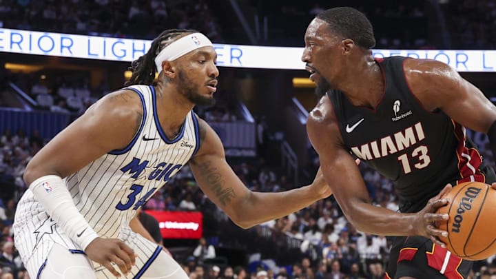 Oct 22, 2025; Orlando, Florida, USA; Miami Heat center Bam Adebayo (13) is guarded by Orlando Magic center Wendell Carter Jr. (34) in the second quarter at Kia Center. Mandatory Credit: Nathan Ray Seebeck-Imagn Images