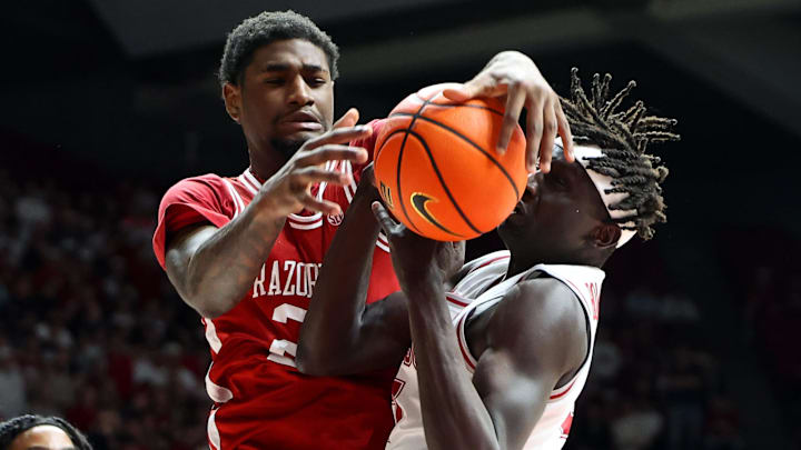 Arkansas Razorback guard Billy Richmond III (24) rebounds against Alabama Crimson Tide forward Taylor Bol Bowen (7) during the first half at Coleman Coliseum in Tuscaloosa, Ala.
