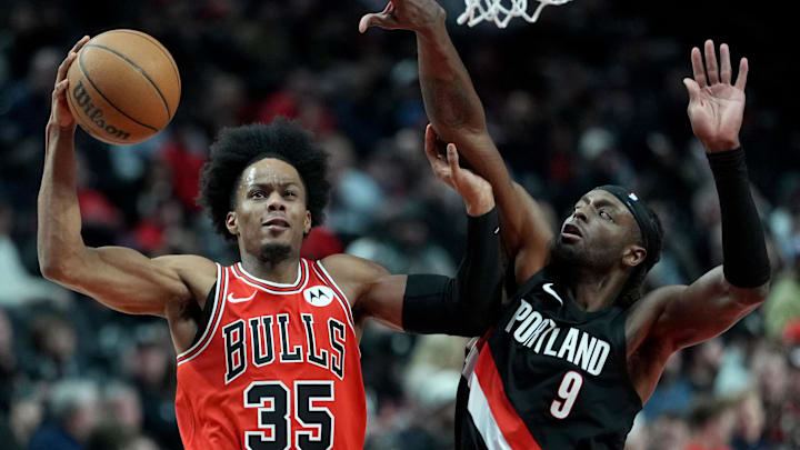Nov 19, 2025; Portland, Oregon, USA; Chicago Bulls forward Isaac Okoro (35) goes up for a shot under pressure from Portland Trail Blazers forward Jerami Grant (9) during the second half at Moda Center. Mandatory Credit: Soobum Im-Imagn Images
