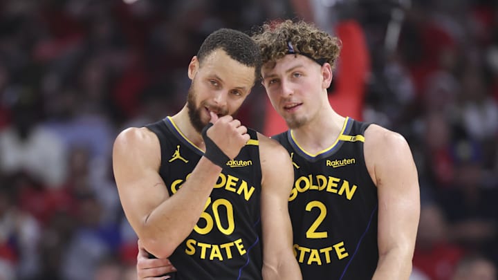 May 4, 2025; Houston, Texas, USA; Golden State Warriors guard Stephen Curry (30) and guard Brandin Podziemski (2) talk during a timeout during game seven of first round for the 2025 NBA Playoffs against the Houston Rockets at Toyota Center. Mandatory Credit: Troy Taormina-Imagn Images
