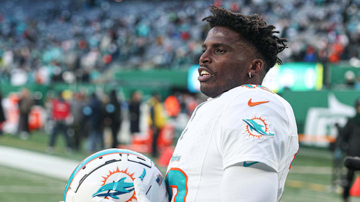 Miami Dolphins wide receiver Tyreek Hill stands on the field after a game.