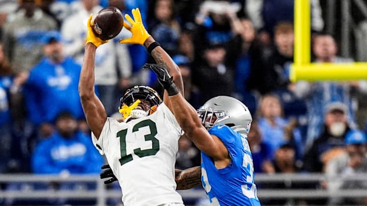 Green Bay Packers wide receiver Dontayvion Wicks (13) makes a catch against Detroit Lions safety Brian Branch (32) Green Bay Packers wide receiver Dontayvion Wicks (13) makes a catch against Detroit Lions safety Brian Branch (32)