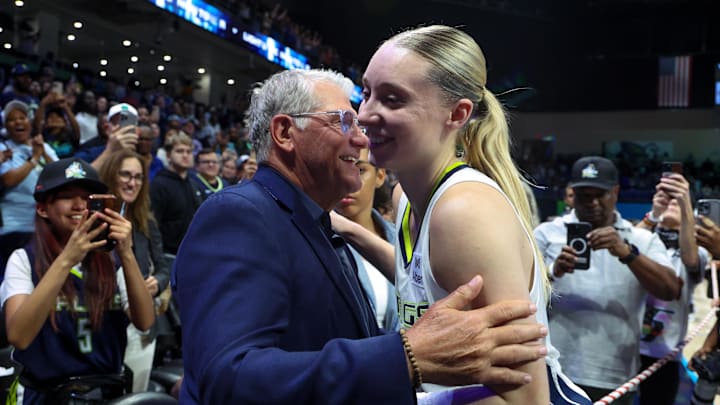 Jun 17, 2025; Arlington, Texas, USA;  University of Connecticut head coach Geno Auriemma hugs Dallas Wings guard Paige Bueckers (5) after the game against the Golden State Valkyries at College Park Center. Mandatory Credit: Kevin Jairaj-Imagn Images
