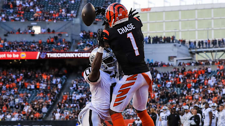 Nov 3, 2024; Cincinnati, Ohio, USA; Cincinnati Bengals wide receiver Ja'Marr Chase (1) attempts to catch a pass against Las Vegas Raiders cornerback Jakorian Bennett (0) in the second half at Paycor Stadium. Mandatory Credit: Katie Stratman-Imagn Images