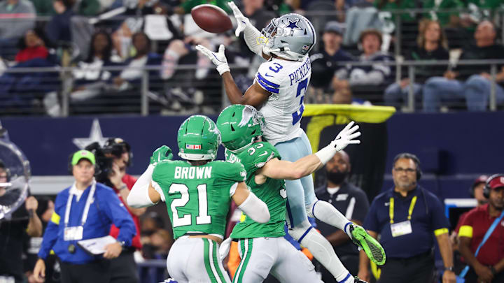 Dallas Cowboys WR George Pickens catches the ball while being defended by Philadelphia Eagles CB Cooper Dejean.