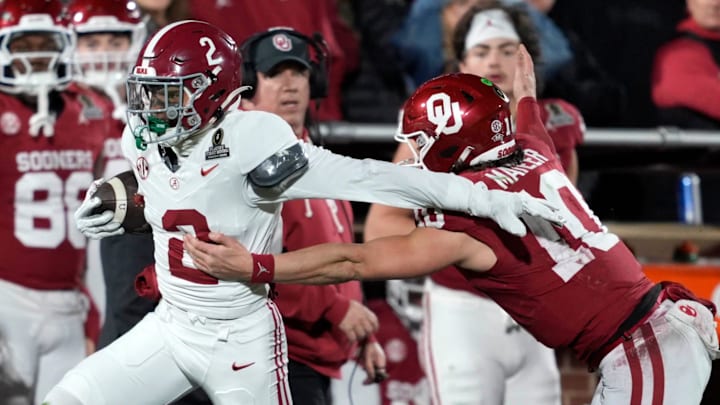 Alabama defensive back Zabien Brown (2) runs past Oklahoma quarterback John Mateer (10) on an interception for a touchdown.