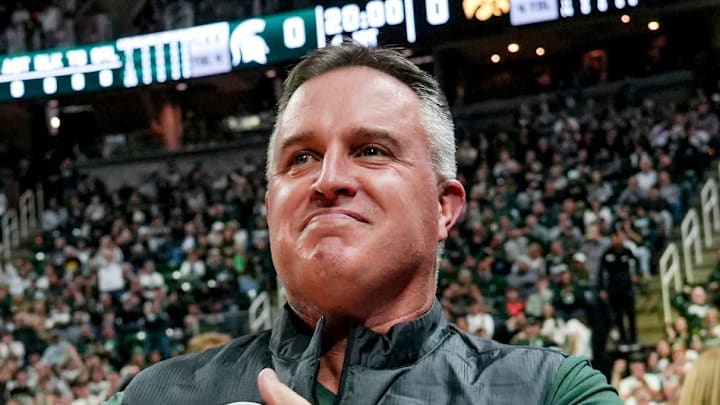 Michigan State's new football coach Pat Fitzgerald pats his heart at the crowd in attendance for the Spartans basketball game against Iowa on Tuesday, Dec. 2, 2025, at the Breslin Center in East Lansing.