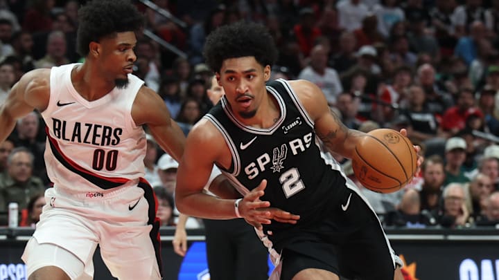 Apr 24, 2026; Portland, Oregon, USA; San Antonio Spurs guard Dylan Harper (2) drives to the basket past Portland Trail Blazers guard Scoot Henderson (00) during the second half during game three of the first round of the 2026 NBA Playoffs at Moda Center. Mandatory Credit: Jaime Valdez-Imagn Images