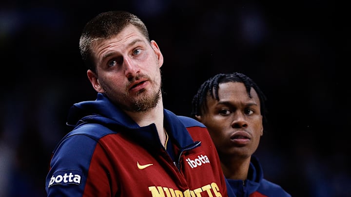Apr 1, 2025; Denver, Colorado, USA; Denver Nuggets center Nikola Jokic (15) and forward Peyton Watson (8) look on from the sideline in the second quarter against the Minnesota Timberwolves at Ball Arena. Mandatory Credit: Isaiah J. Downing-Imagn Images
