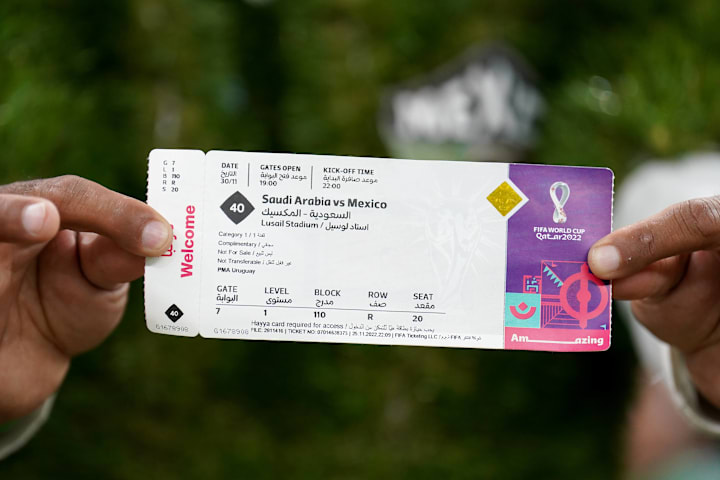 A person displays a 2022 World Cup admission pass for a match between Saudi Arabia and Mexico, A person displays a 2022 World Cup admission pass for a match between Saudi Arabia and Mexico,