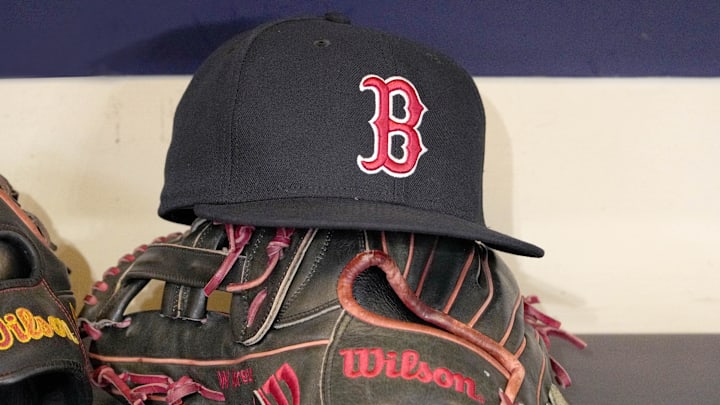 May 27, 2025; Milwaukee, Wisconsin, USA; A Boston Red Sox hat and glove sit in the dug out before a game against the Milwaukee Brewers at American Family Field. 