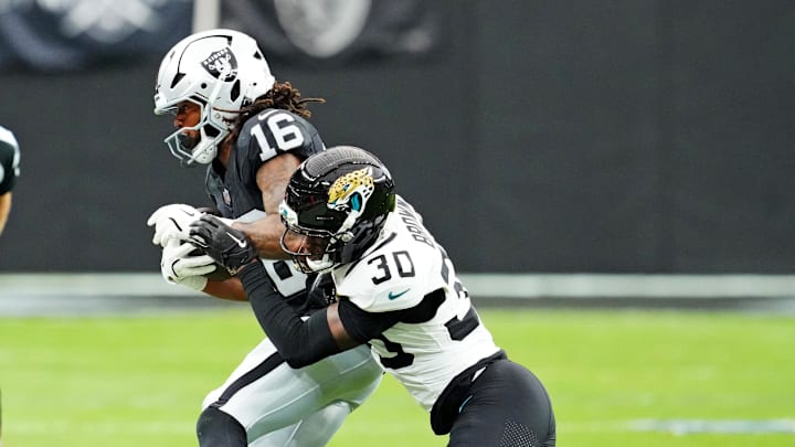 Nov 2, 2025; Paradise, Nevada, USA; Jacksonville Jaguars cornerback Montaric Brown (30) tackles Las Vegas Raiders wide receiver Jakobi Meyers (16) during the second half at Allegiant Stadium. Mandatory Credit: Stephen R. Sylvanie-Imagn Images