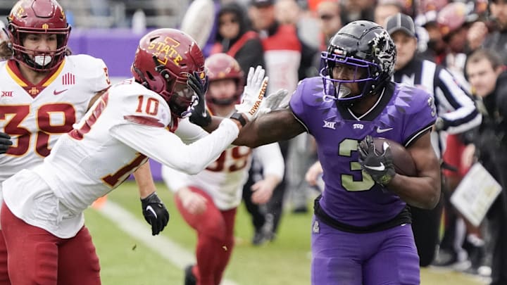 TCU Horned Frogs running back Emari Demercado is knocked out of bounds by Iowa State Cyclones defensive back Darien Porter.