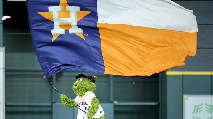 Houston Astros mascot Orbit waves a flag Houston Astros mascot Orbit waves a flag