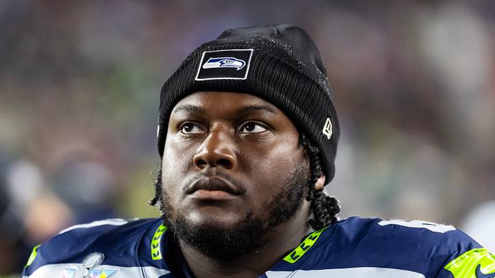 Seattle Seahawks guard Christian Haynes looks at the scoreboard