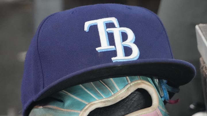 Sep 26, 2025; Toronto, Ontario, CAN; The hat and glove of Tampa Bay Rays third baseman Junior Caminero (13) in the dugout during the game against the Toronto Blue Jays at Rogers Centre. 