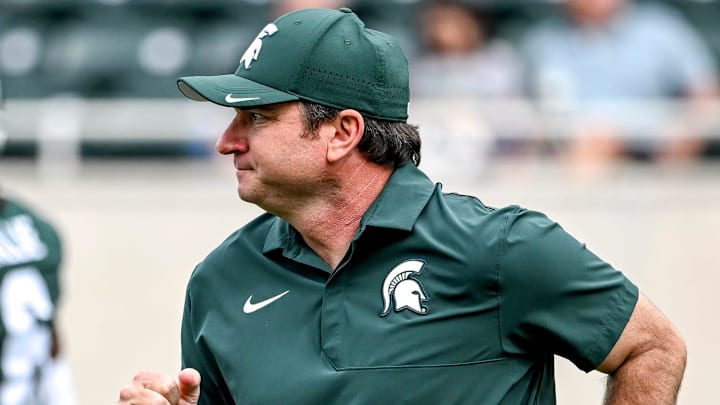 Michigan State's head coach Jonathan Smith jogs back to the sideline before the game against Youngstown State on Saturday, Sept. 13, 2025, at Spartan Stadium in East Lansing.