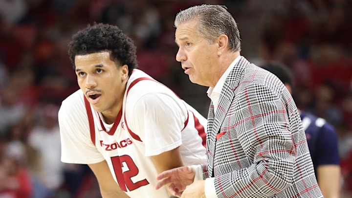 Arkansas Razorbacks forward Malique Ewin (12) talks to coach John Calipari during the second half against the Jackson State Tigers at Bud Walton Arena. Arkansas won 115-61.